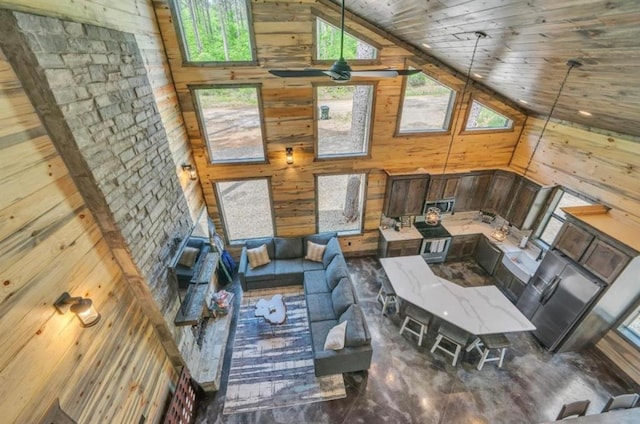 interior space with wooden walls, high vaulted ceiling, and wood ceiling