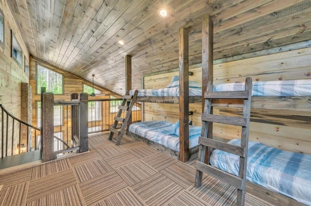 unfurnished bedroom featuring vaulted ceiling, wood ceiling, and wood walls