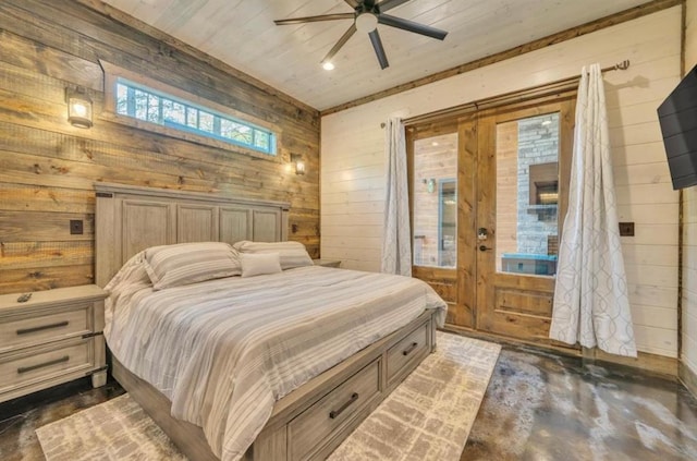 bedroom with ceiling fan, wooden ceiling, and wood walls