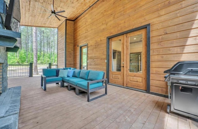 wooden terrace with french doors, an outdoor living space, ceiling fan, and a grill