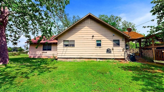 back of property featuring a yard and a deck