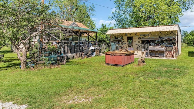 view of yard with an outbuilding and a hot tub