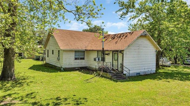 back of property featuring a lawn