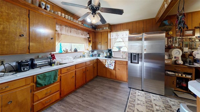 kitchen with stainless steel fridge, light wood-type flooring, ceiling fan, and sink