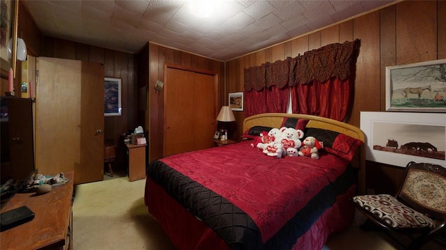 bedroom featuring wood walls and light colored carpet