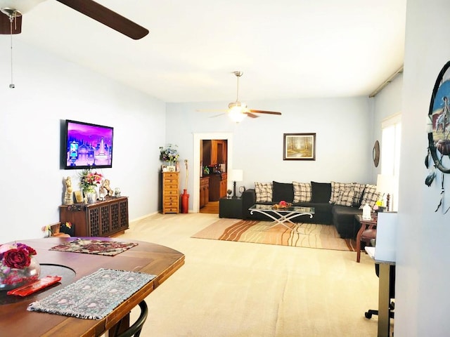 carpeted living room with ceiling fan