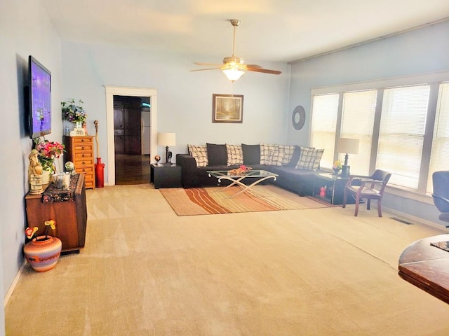 carpeted living room featuring ceiling fan