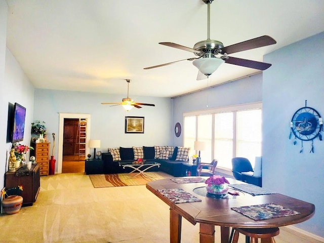 living room with ceiling fan and light colored carpet
