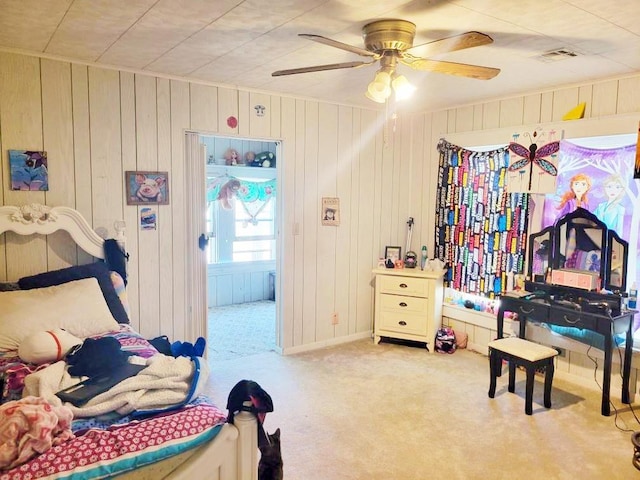 bedroom with wood walls, visible vents, and carpet floors