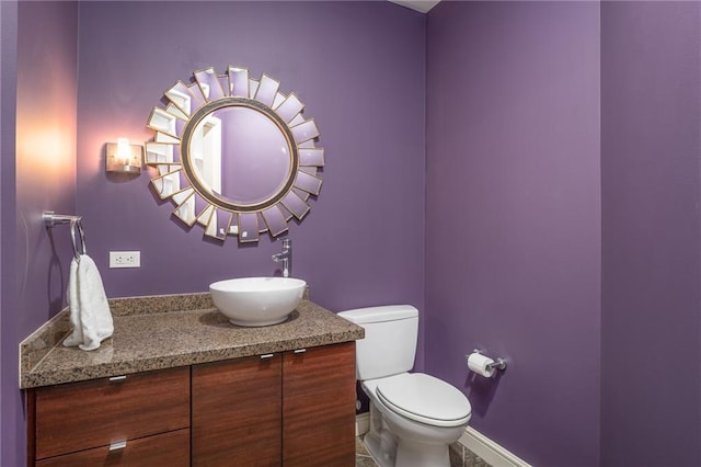 bathroom featuring tile patterned floors, vanity, and toilet