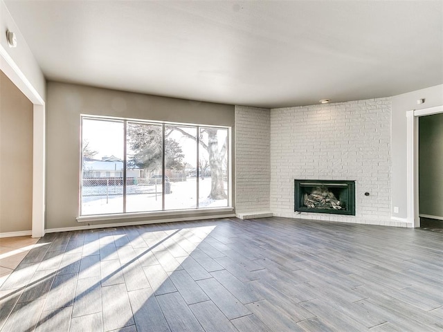 unfurnished living room featuring light hardwood / wood-style floors and a fireplace