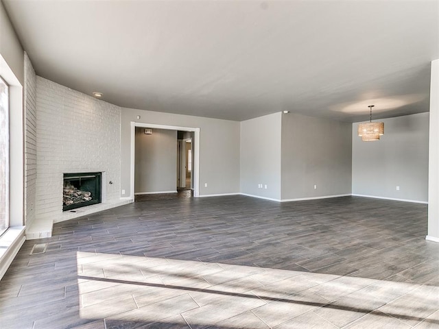 unfurnished living room with hardwood / wood-style flooring and a fireplace