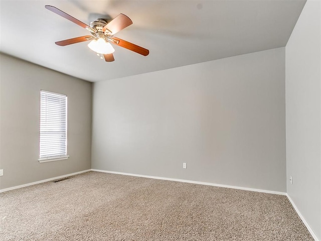 empty room with ceiling fan and carpet