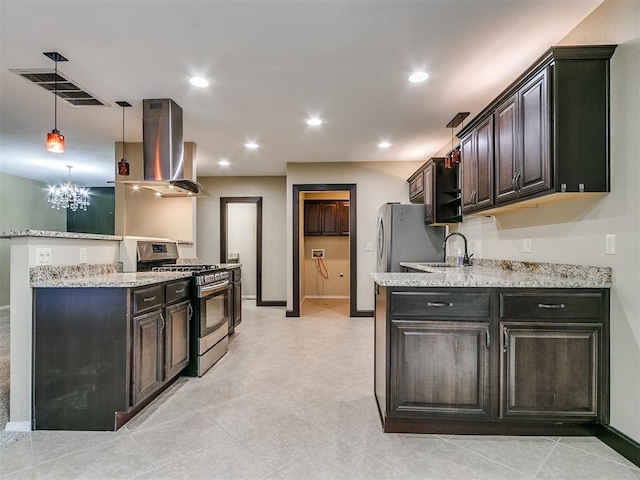 kitchen featuring wall chimney range hood, dark brown cabinetry, sink, and stainless steel range with gas stovetop