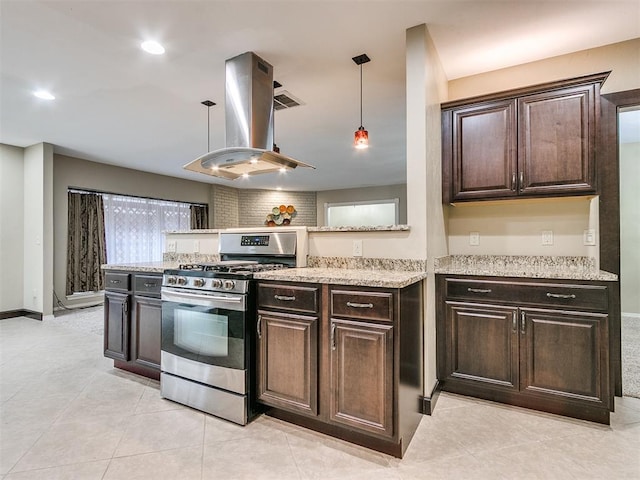 kitchen featuring pendant lighting, island range hood, stainless steel range with gas cooktop, and dark brown cabinets