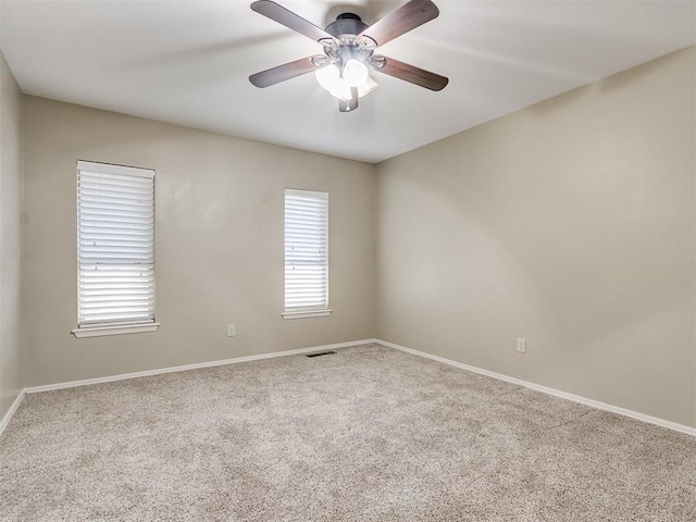 spare room featuring carpet flooring and ceiling fan