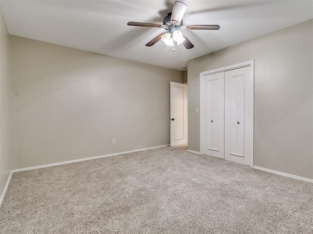 unfurnished bedroom with ceiling fan, a closet, and carpet