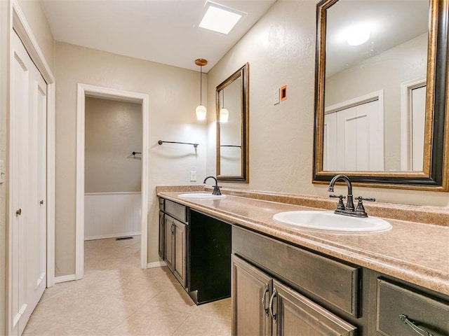 bathroom with tile patterned flooring and vanity