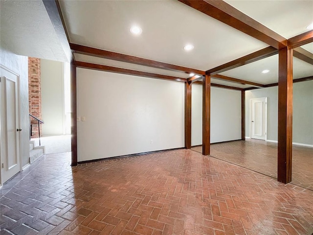 empty room featuring beam ceiling