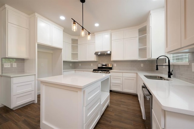 kitchen featuring a center island, white cabinets, sink, dark hardwood / wood-style floors, and decorative light fixtures