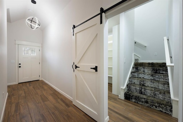 foyer with dark hardwood / wood-style flooring and a barn door