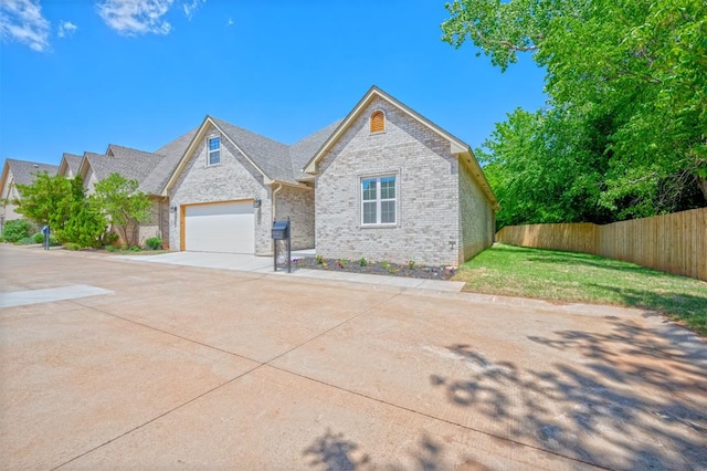 view of front of home with a front lawn and a garage