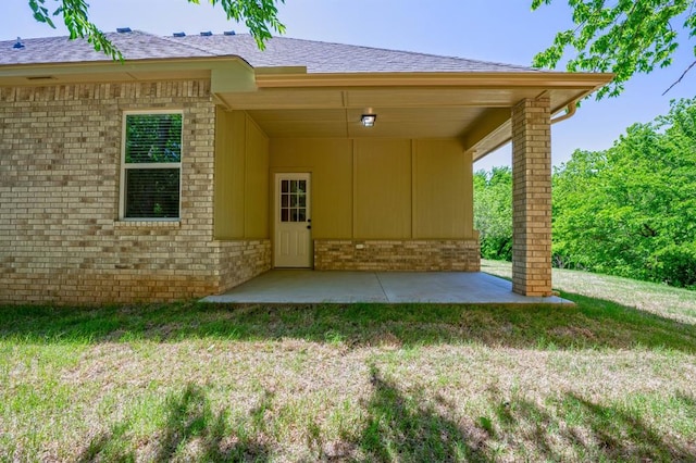 rear view of house featuring a yard and a patio