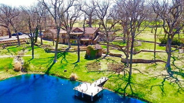 surrounding community featuring a water view and a lawn