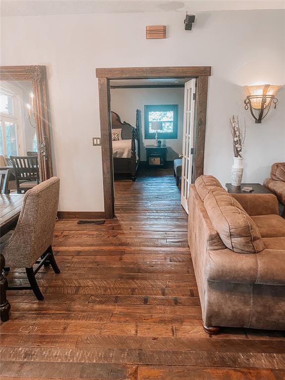 hallway with dark wood-type flooring and french doors