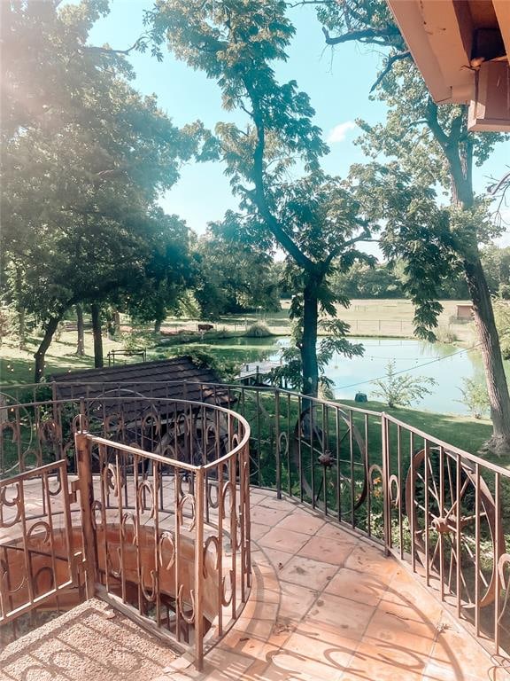 view of patio / terrace featuring a balcony and a water view