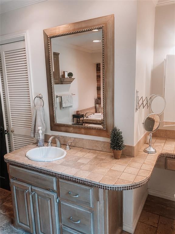 bathroom with vanity and crown molding