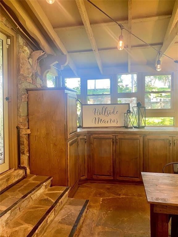 interior space with beam ceiling and plenty of natural light