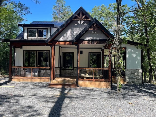 view of front of house featuring solar panels and covered porch