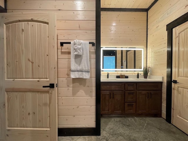 bathroom with vanity and wooden walls