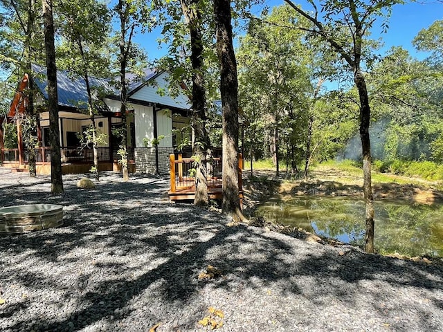 view of yard featuring a deck with water view