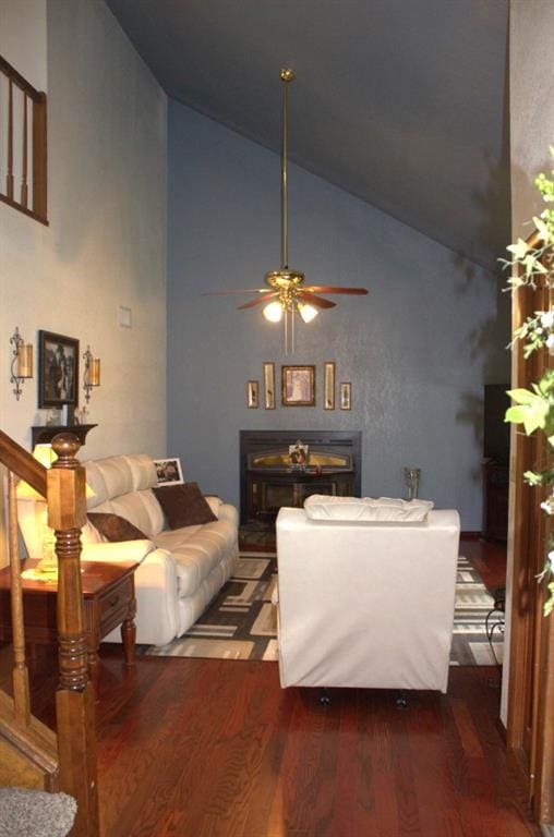 living room featuring dark hardwood / wood-style floors, ceiling fan, and high vaulted ceiling