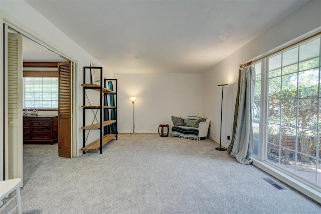 living area with light carpet