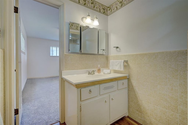 bathroom with vanity and tile walls