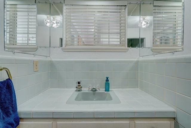 bathroom featuring vanity and tasteful backsplash