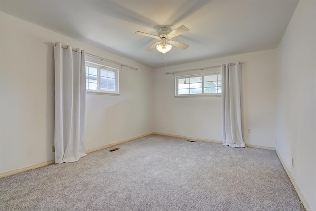 carpeted empty room with ceiling fan