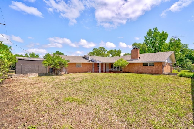 rear view of house featuring a lawn