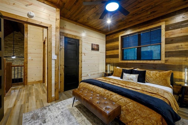 bedroom with wood ceiling, hardwood / wood-style flooring, and wood walls