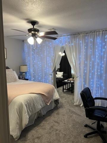 carpeted bedroom with ceiling fan and a textured ceiling