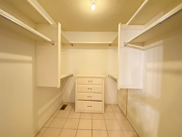 spacious closet featuring light tile patterned flooring