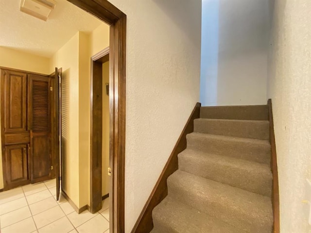 stairs with tile patterned flooring