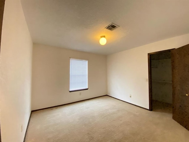 unfurnished room featuring light colored carpet