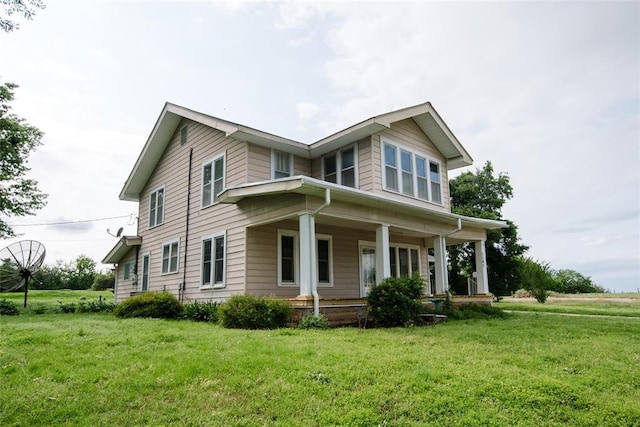 view of front of house with covered porch and a front lawn