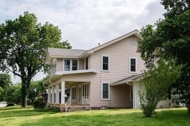 back of house with a yard and a porch