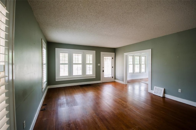 interior space with hardwood / wood-style floors and a textured ceiling