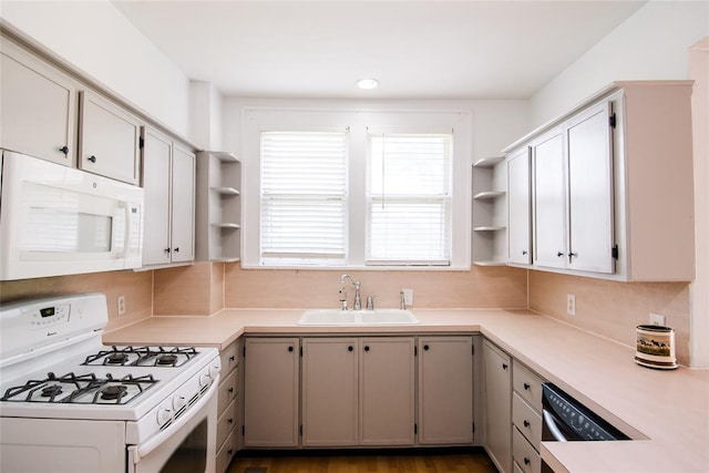 kitchen featuring white appliances and sink